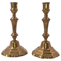 Pair of bronze candlesticks with ornate design.