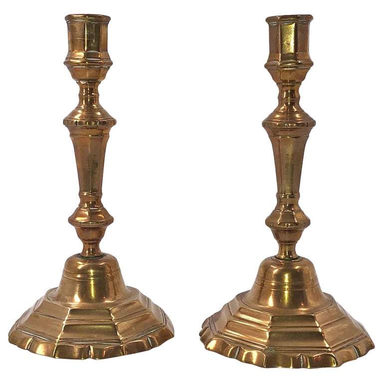 Pair of bronze candlesticks with ornate design.