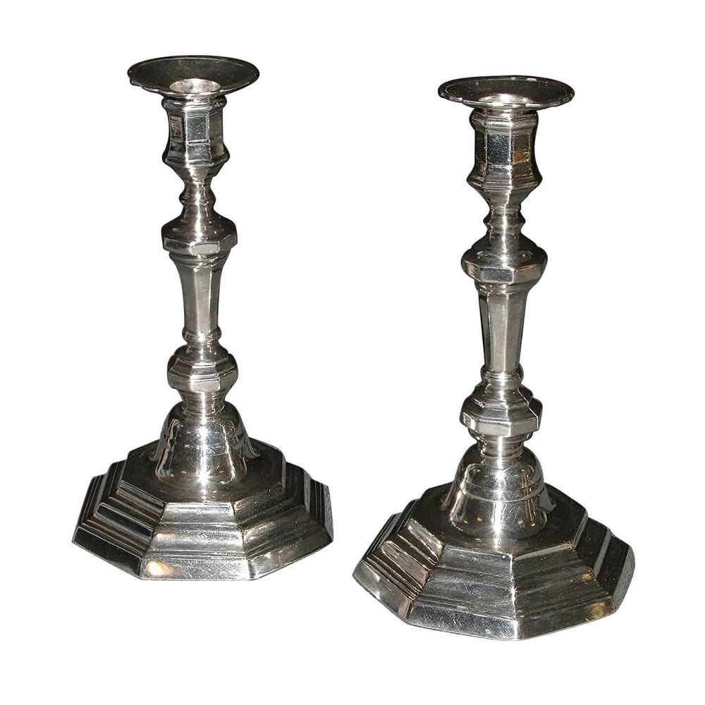 Pair of French Louis XVI candlesticks, angled view.
