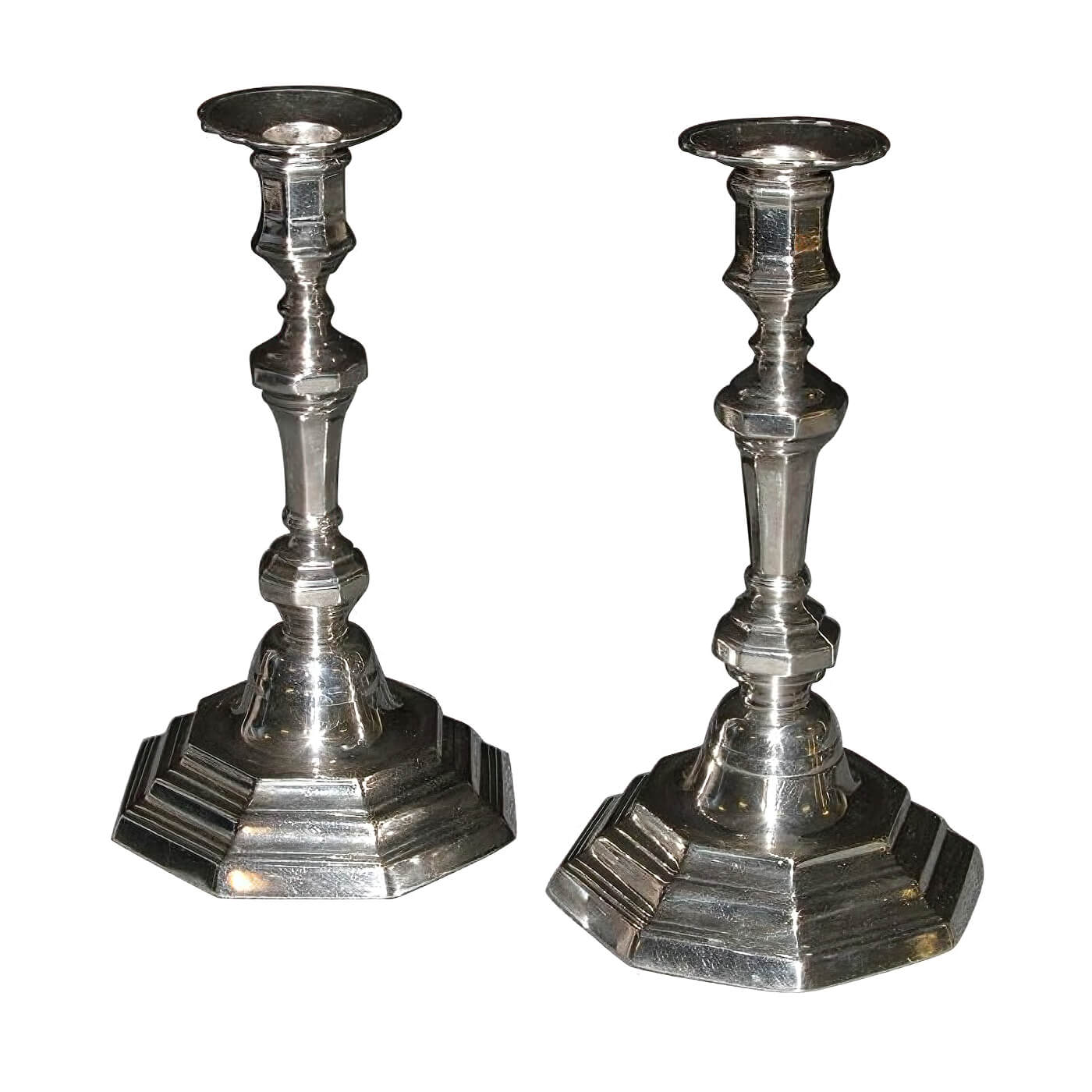 Pair of French Louis XVI candlesticks, angled view.