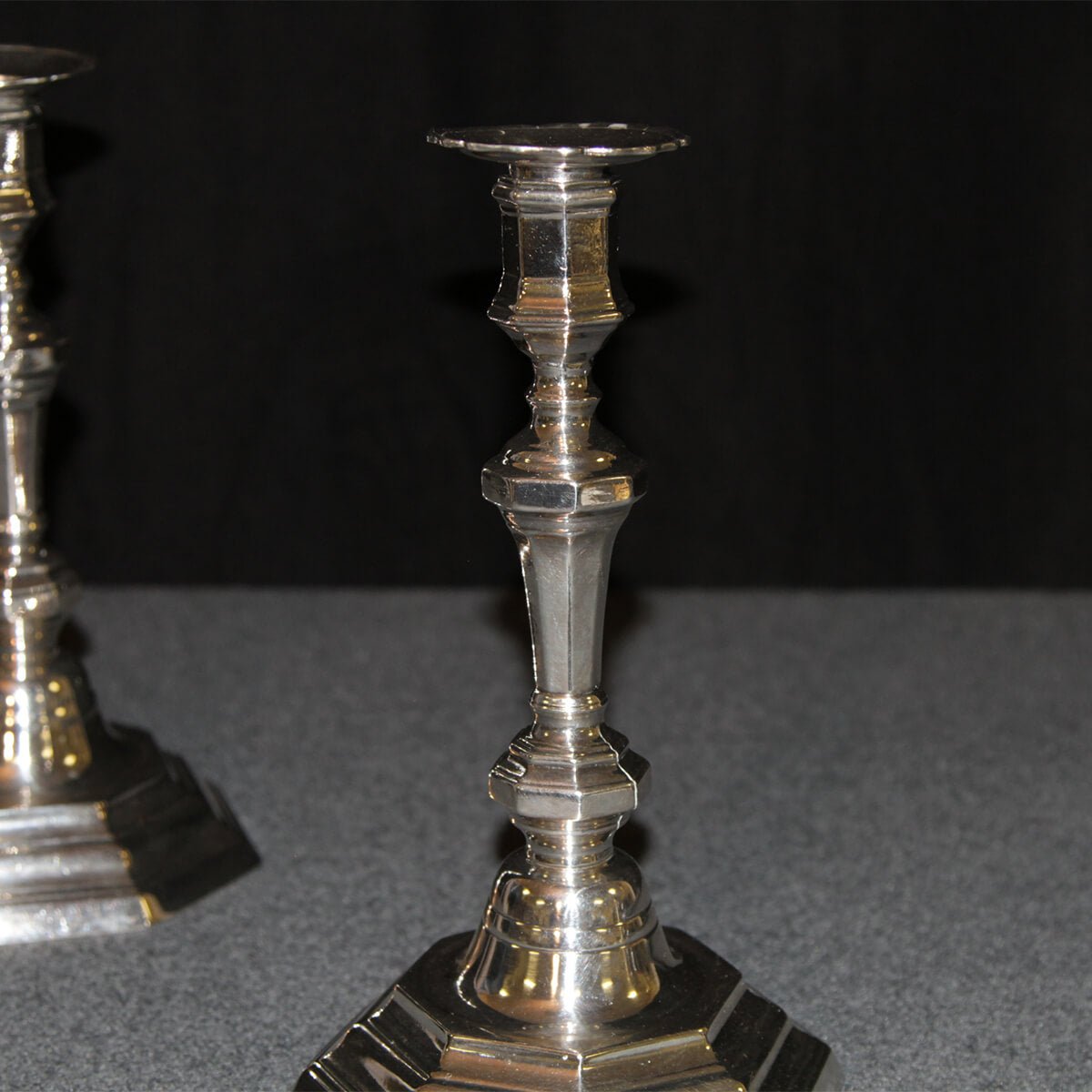 Close-up of one French candlestick, detailed design visible.