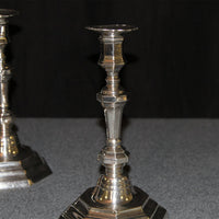 Close-up of one French candlestick, detailed design visible.