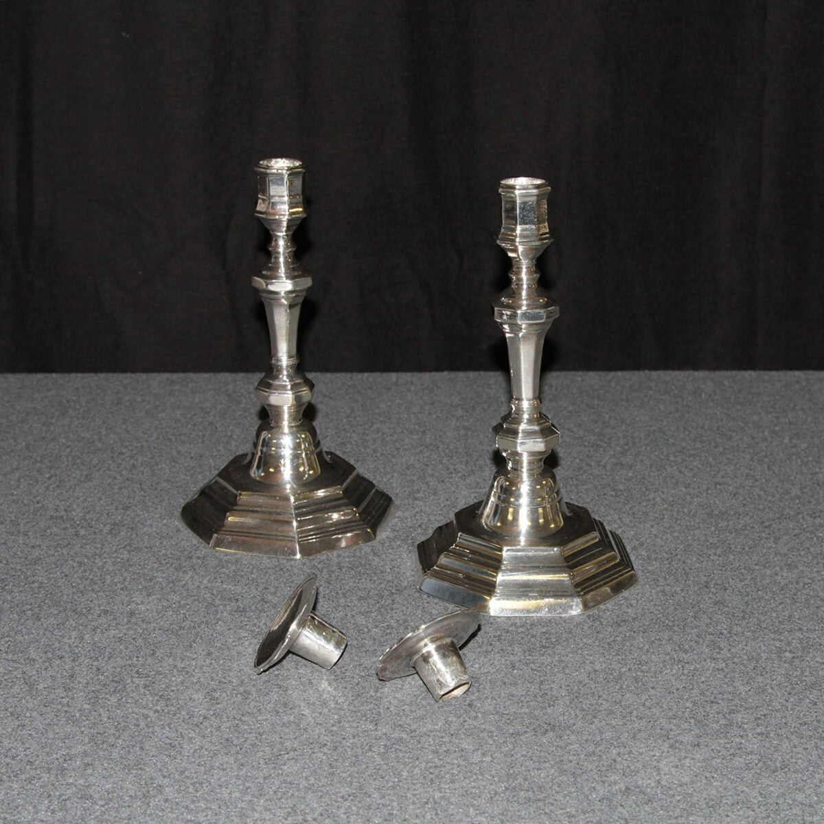 French candlesticks with removable tops, displayed on table.
