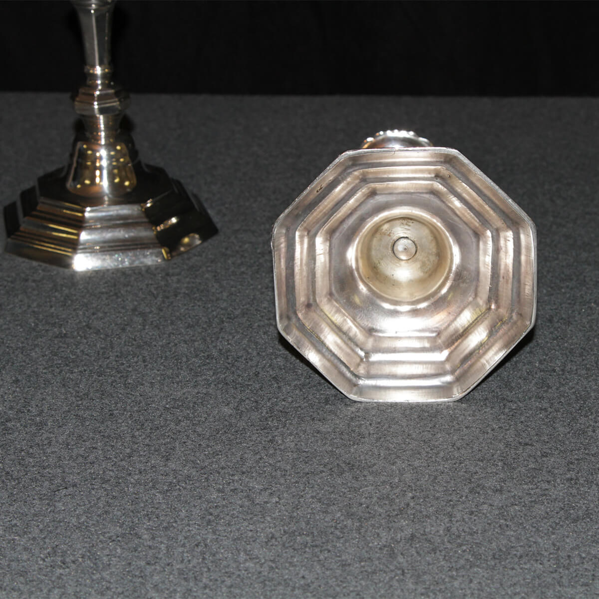 Underside of French candlestick, base design visible.