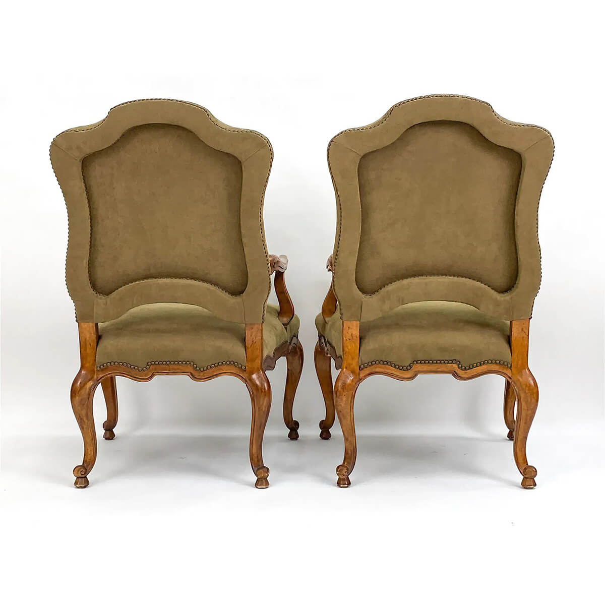 Rear view of French provincial antique armchairs.