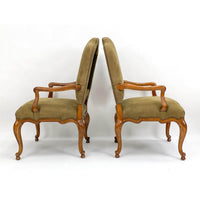 Back-to-back side view of antique armchairs.