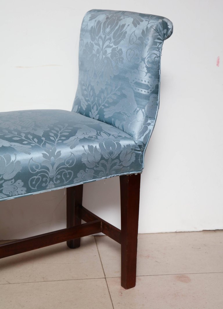 Close-up of blue upholstery on bench, armrest detail.