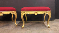 Close-up of ornate gold legs on red stool