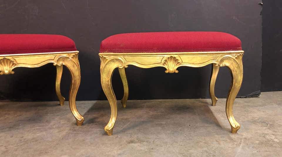 Close-up of ornate gold legs on red stool