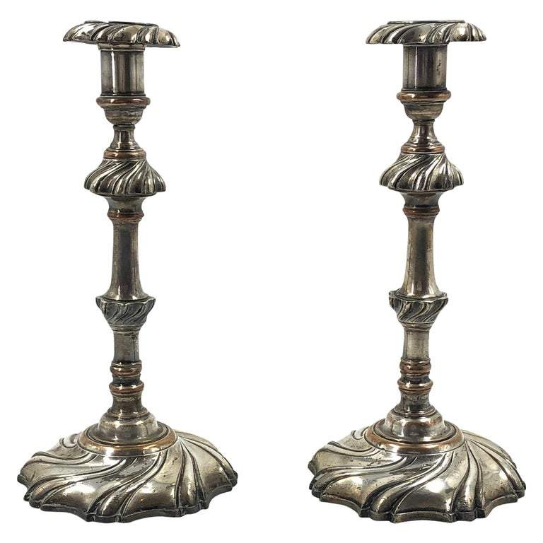 Pair of Georgian silvered candlesticks, full view.