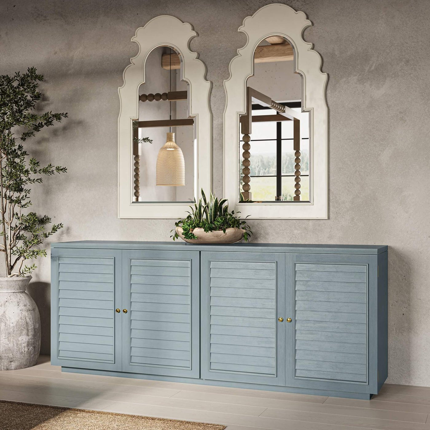 Two white mirrors above blue sideboard, modern decor.