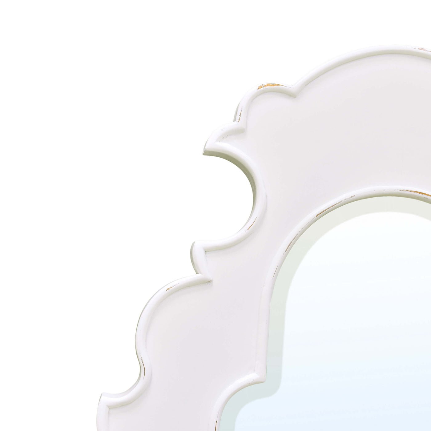 Close-up of ornate white mirror frame detail.