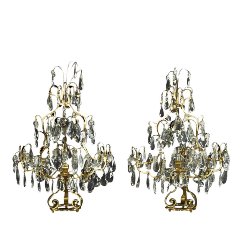 Pair of Louis XIV girandoles, lit background, intricate design
