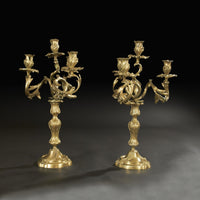 Elegant bronze candelabra, dark background, detailed view.