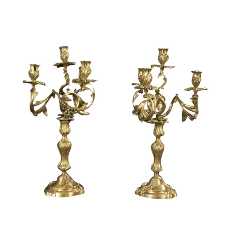 Vintage bronze candelabra on white background, intricate design.