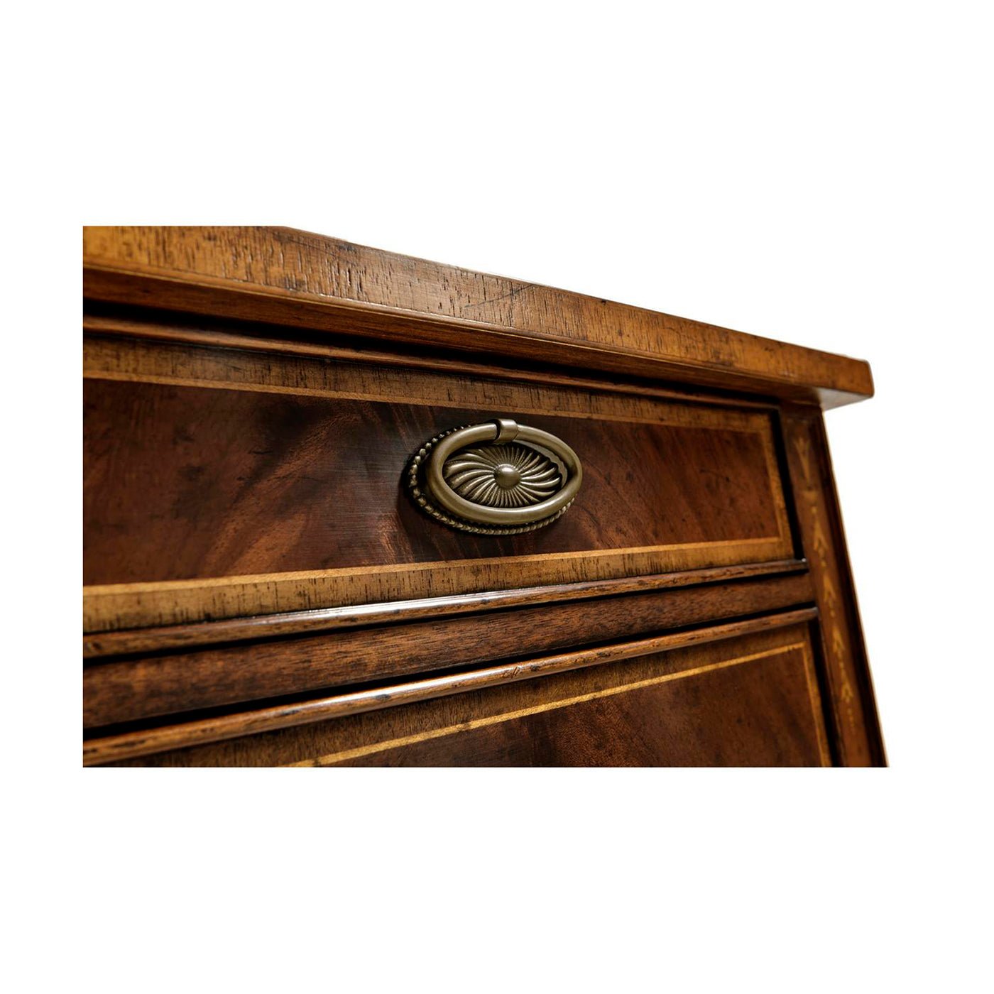 Close-up of mahogany bedside cabinet drawer handle.