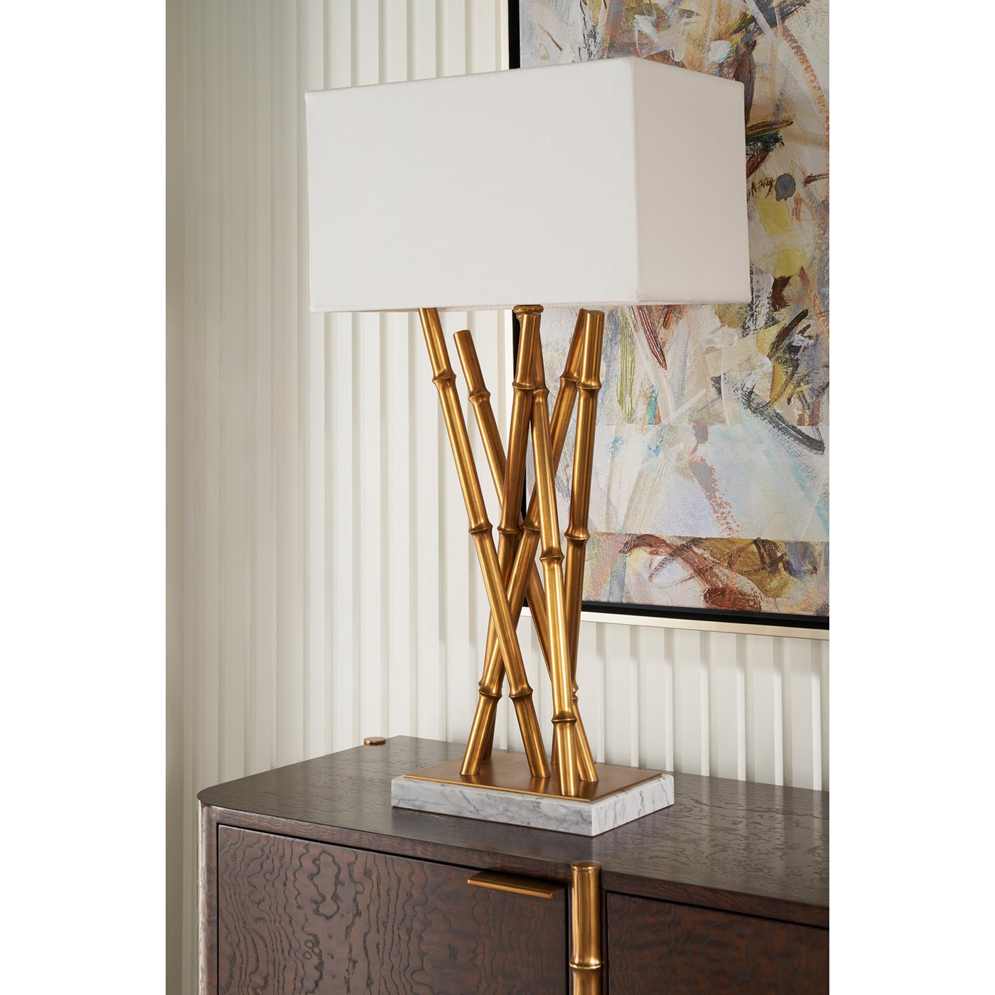 Single lamp on dark wood cabinet, artistic backdrop.