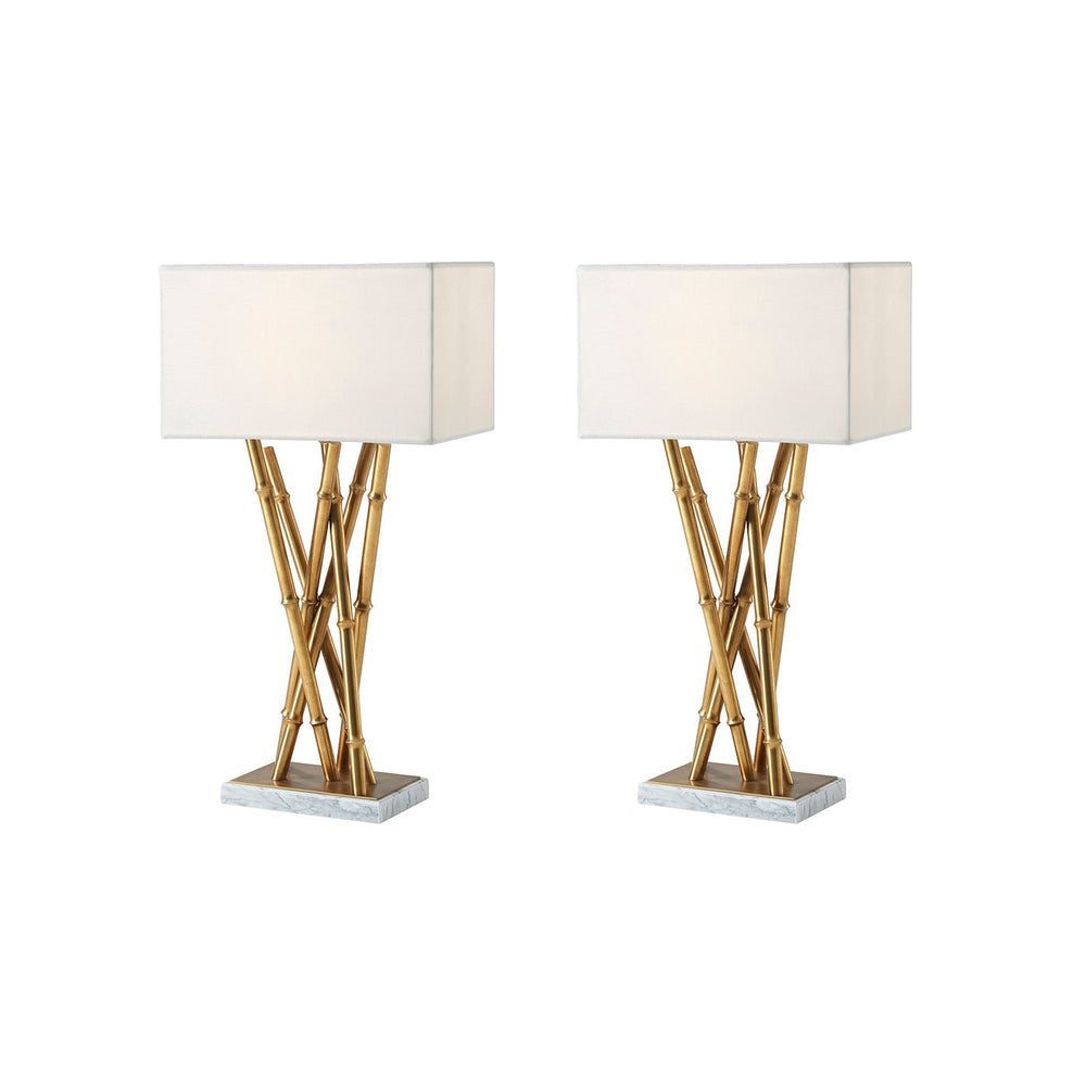 Pair of brass table lamps with white shades.