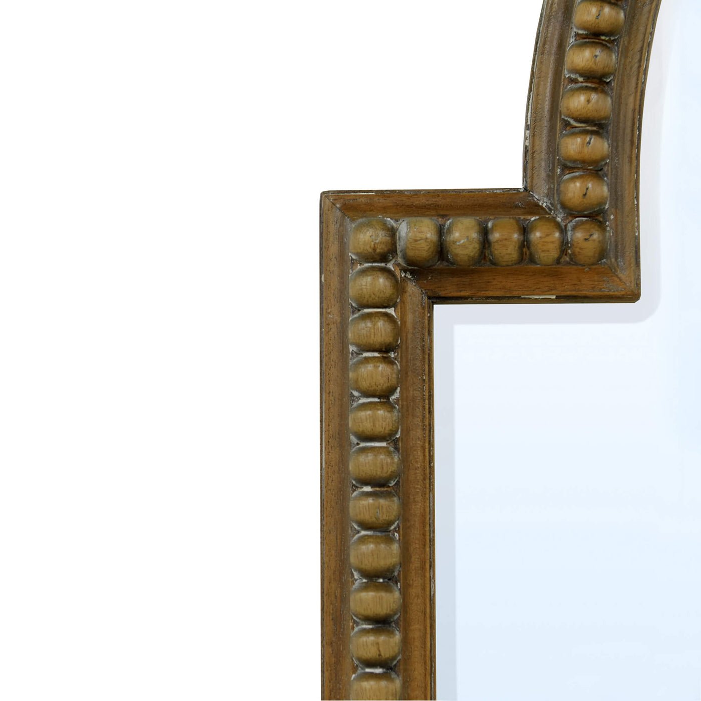 Close-up of ornate frame on Queen Anne style mirror.