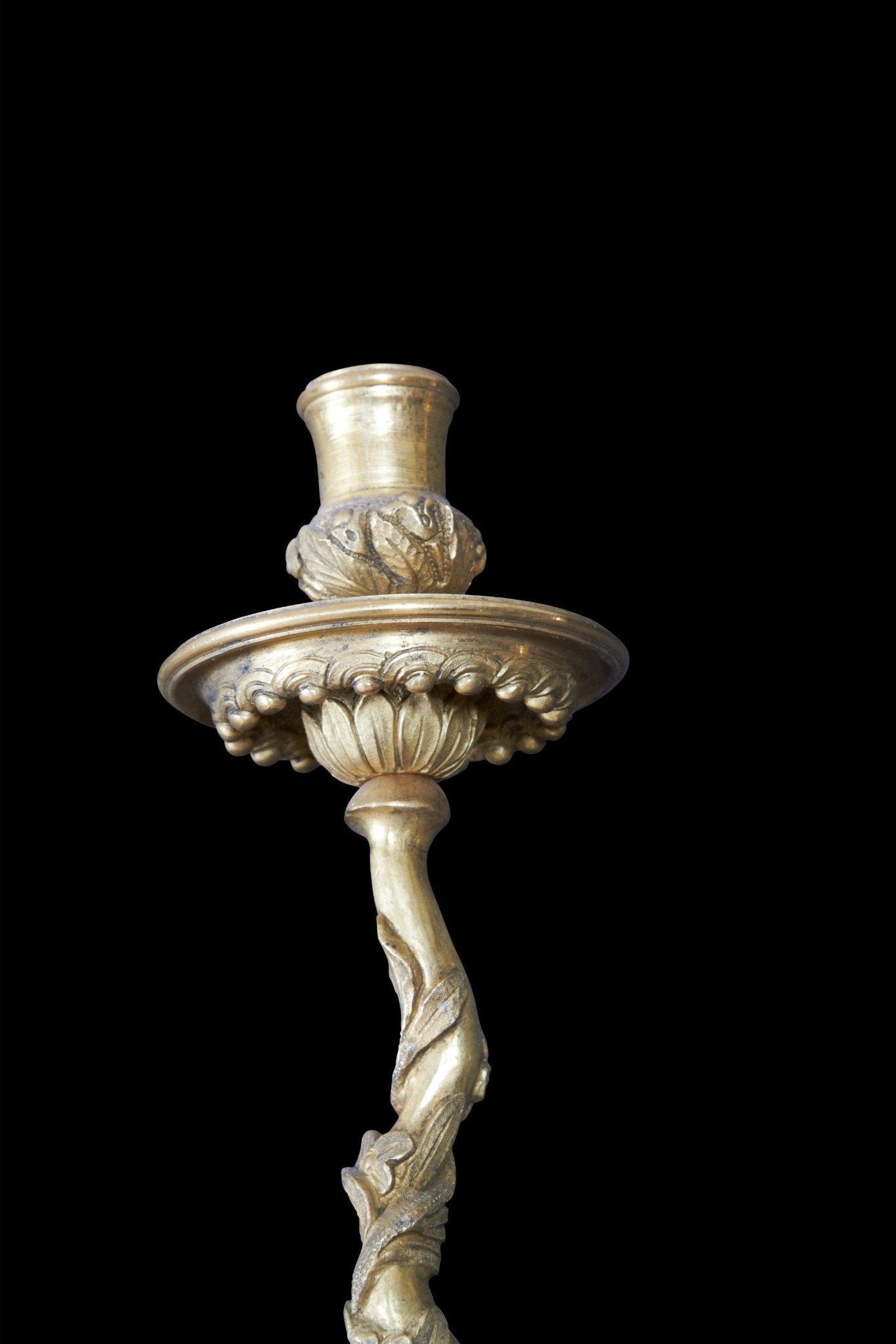 Close-up of bronze sconce candle holder and arm.
