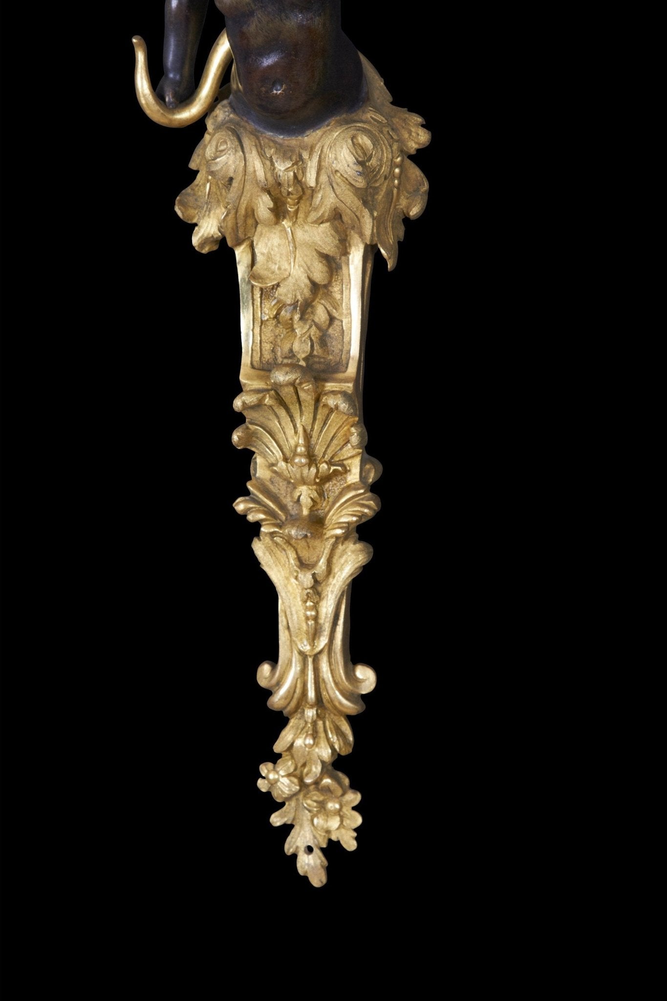 Intricate bronze detailing on sconce bottom section.