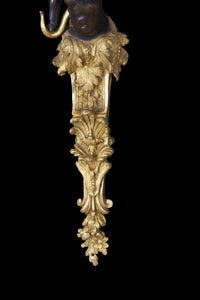 Intricate bronze detailing on sconce bottom section.