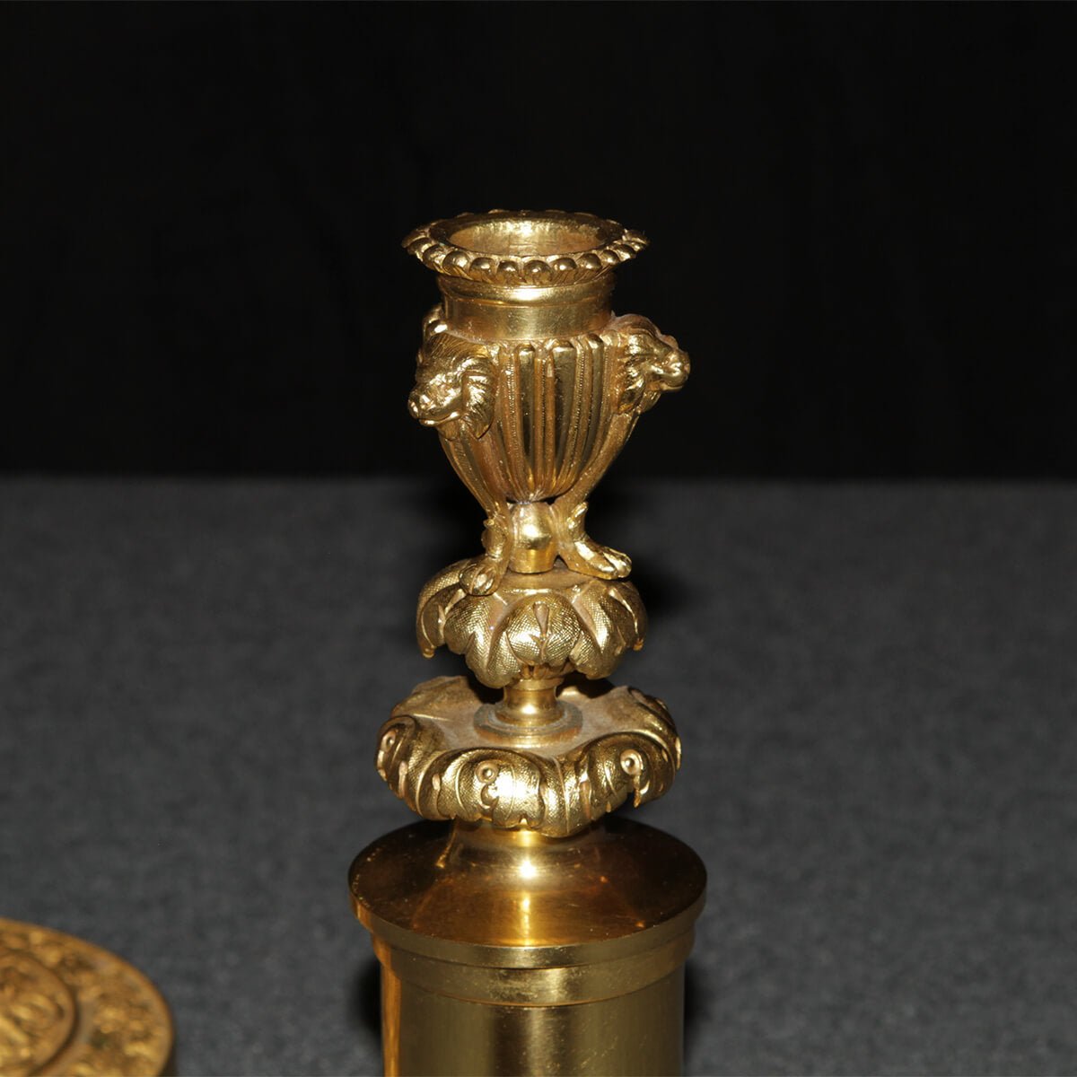 Close-up of ornate top section of candlestick.