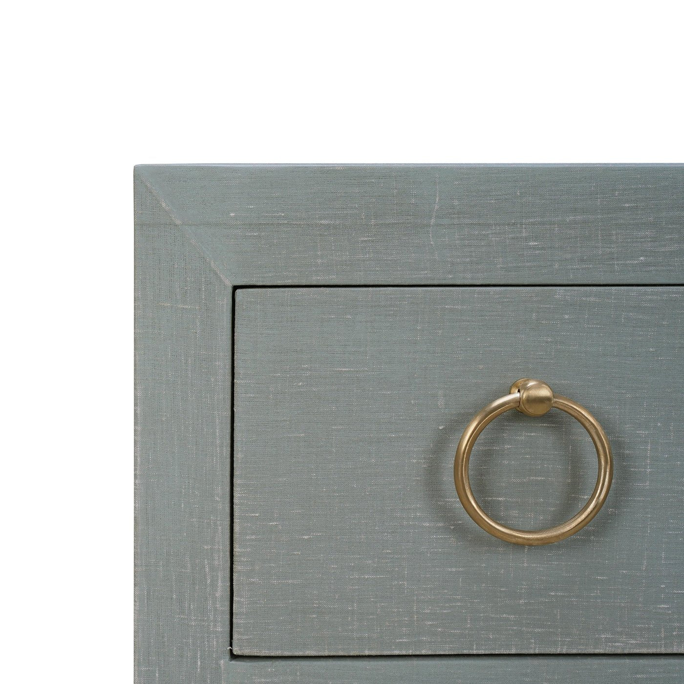 Close-up corner view of chest of drawers.