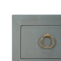 Close-up corner view of chest of drawers.