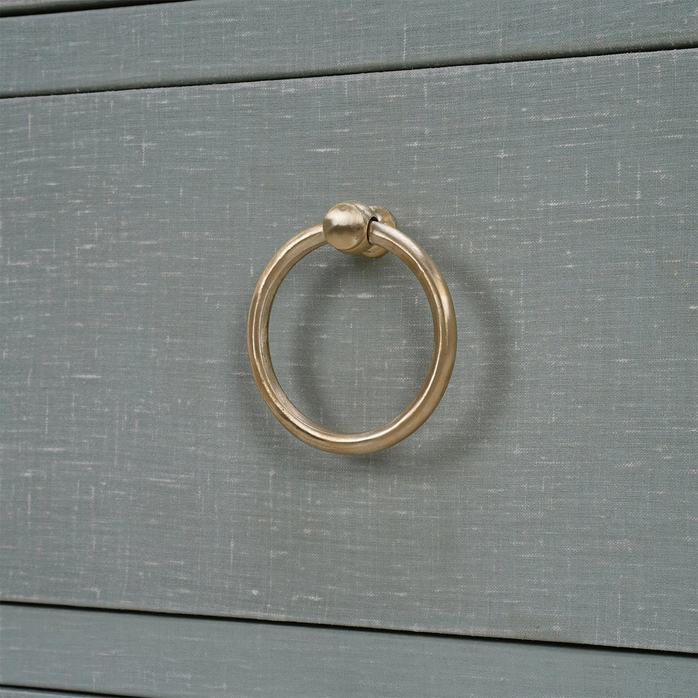 Close-up of drawer handle on chest of drawers.