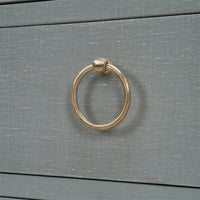 Close-up of drawer handle on chest of drawers.