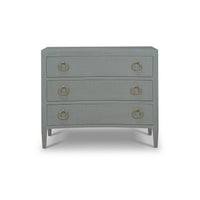 Front view of linen wrapped chest of drawers.