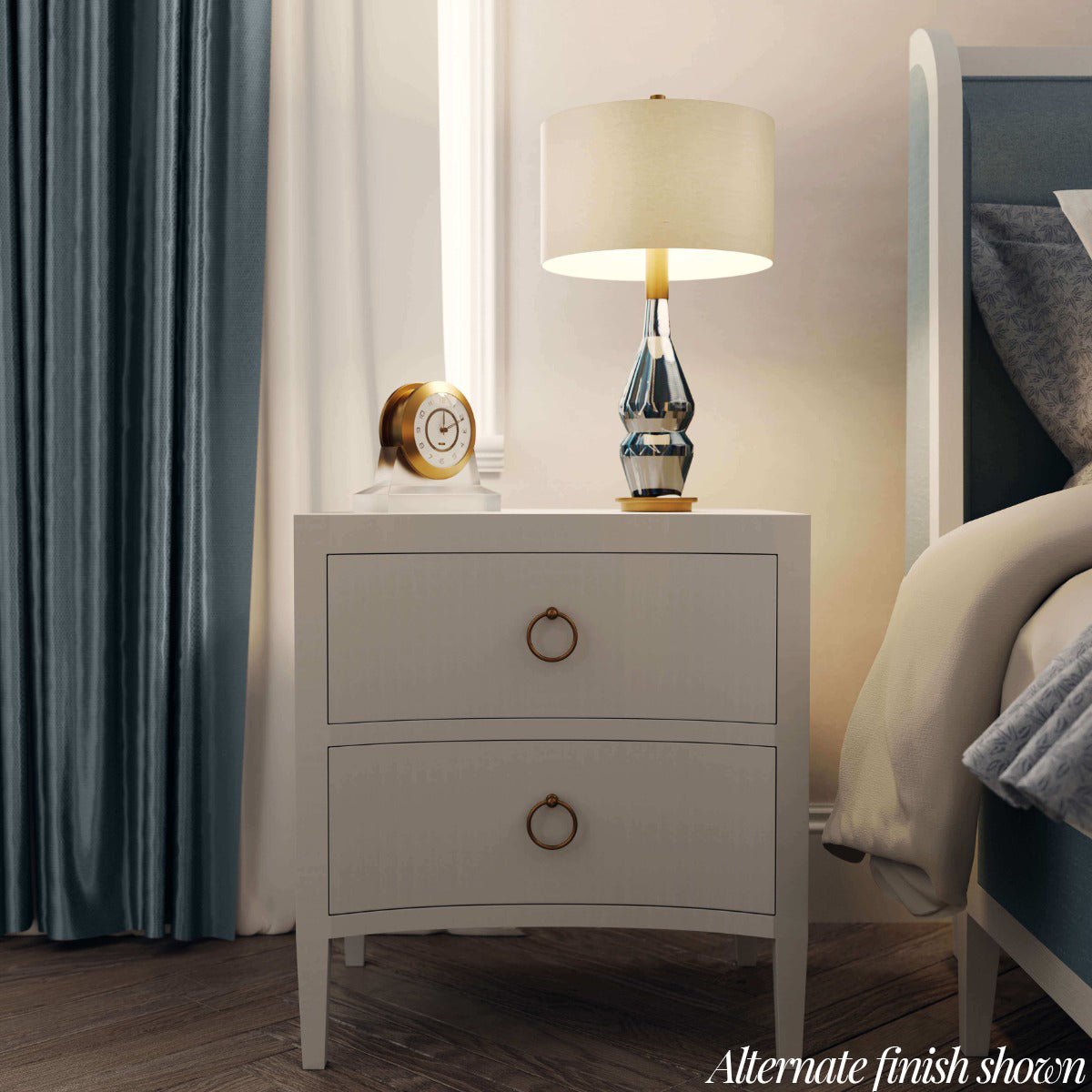 Styled nightstand in bedroom, lamp and clock on top.