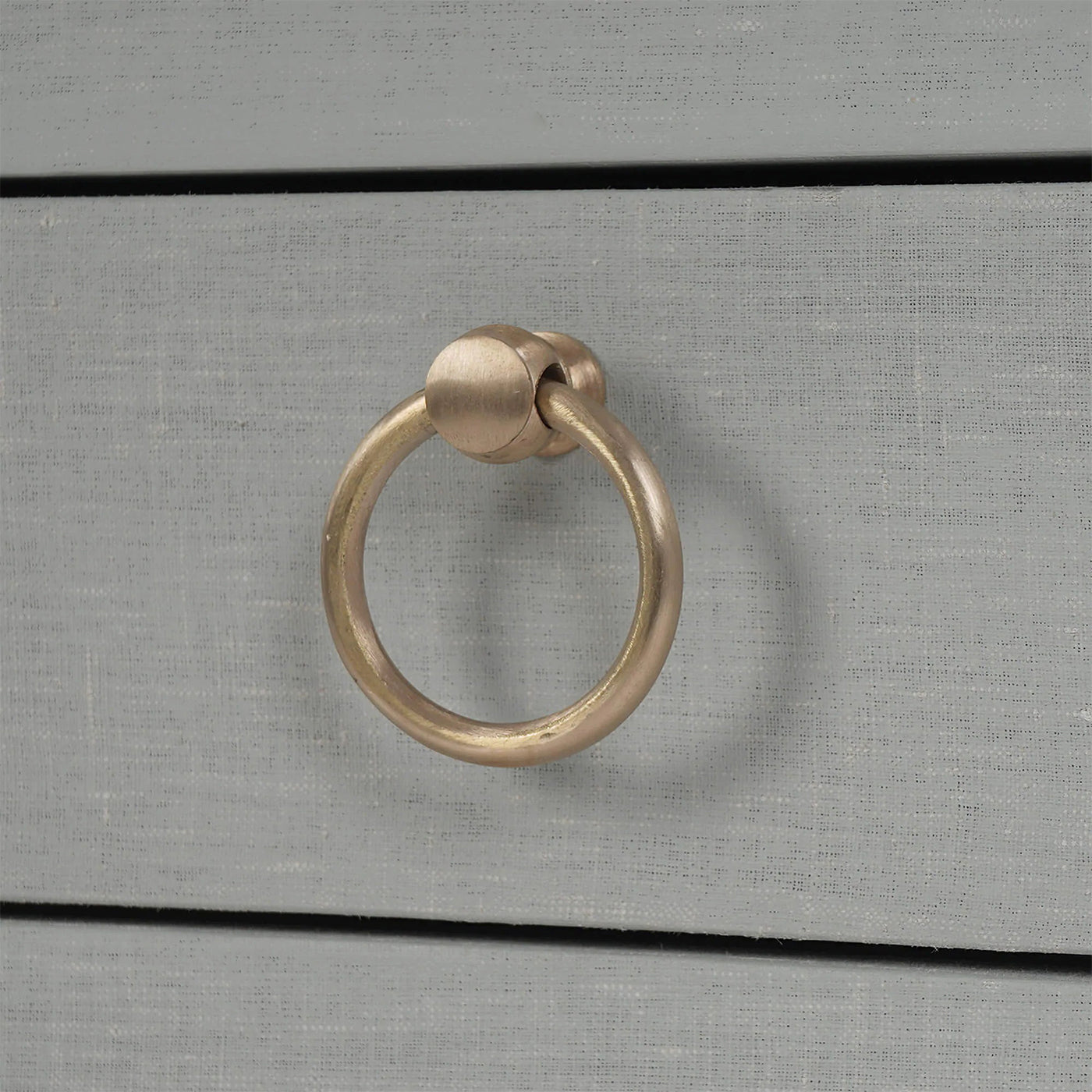 Drawer handle detail pale blue linen nightstand.
