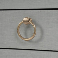 Drawer handle detail pale blue linen nightstand.