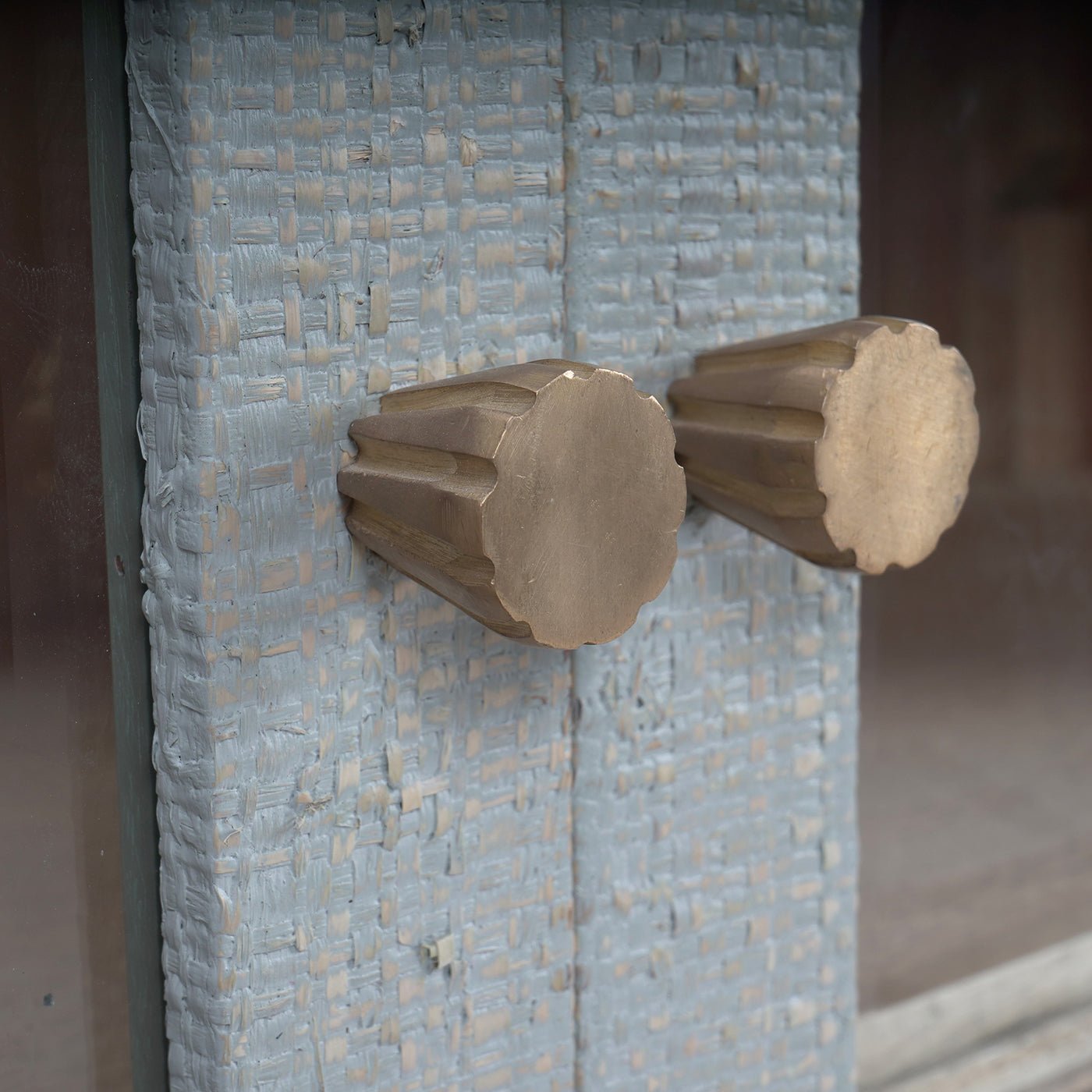 Close-up of the china cabinet's brass knob detail.