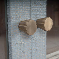 Close-up of the china cabinet's brass knob detail.