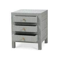 Bedside table, partially open drawers, pale blue raffia.