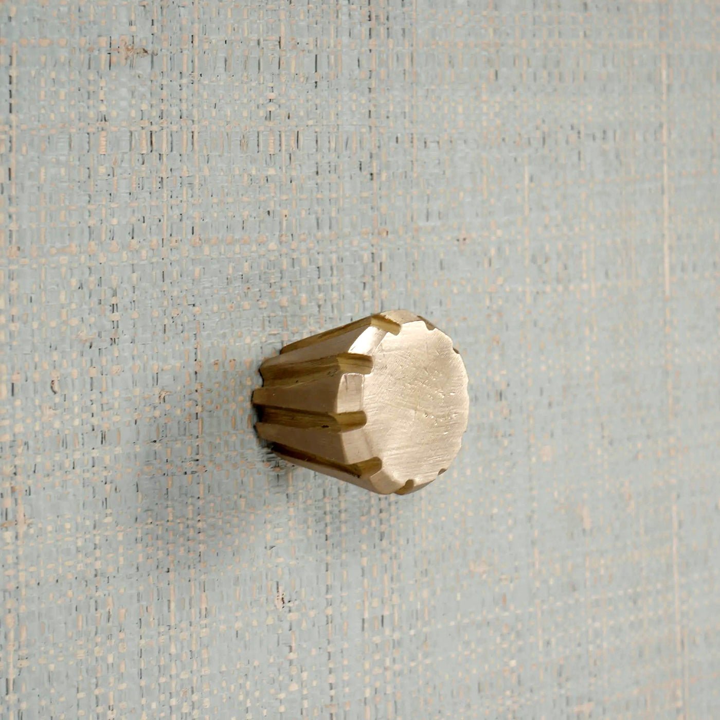 Close-up of knob on raffia nightstand drawer.