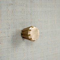 Close-up of knob on raffia nightstand drawer.