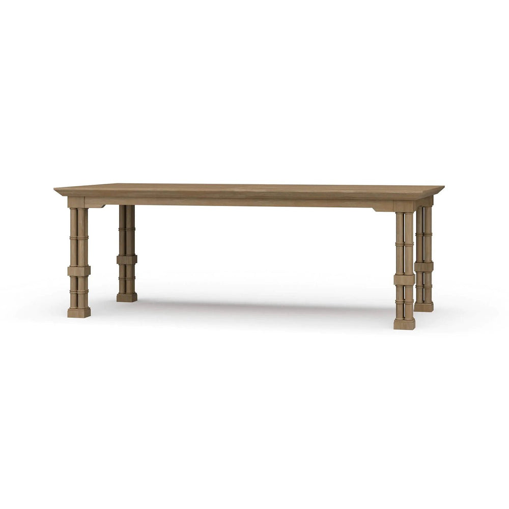 Wooden dining table angled view with ornate legs.