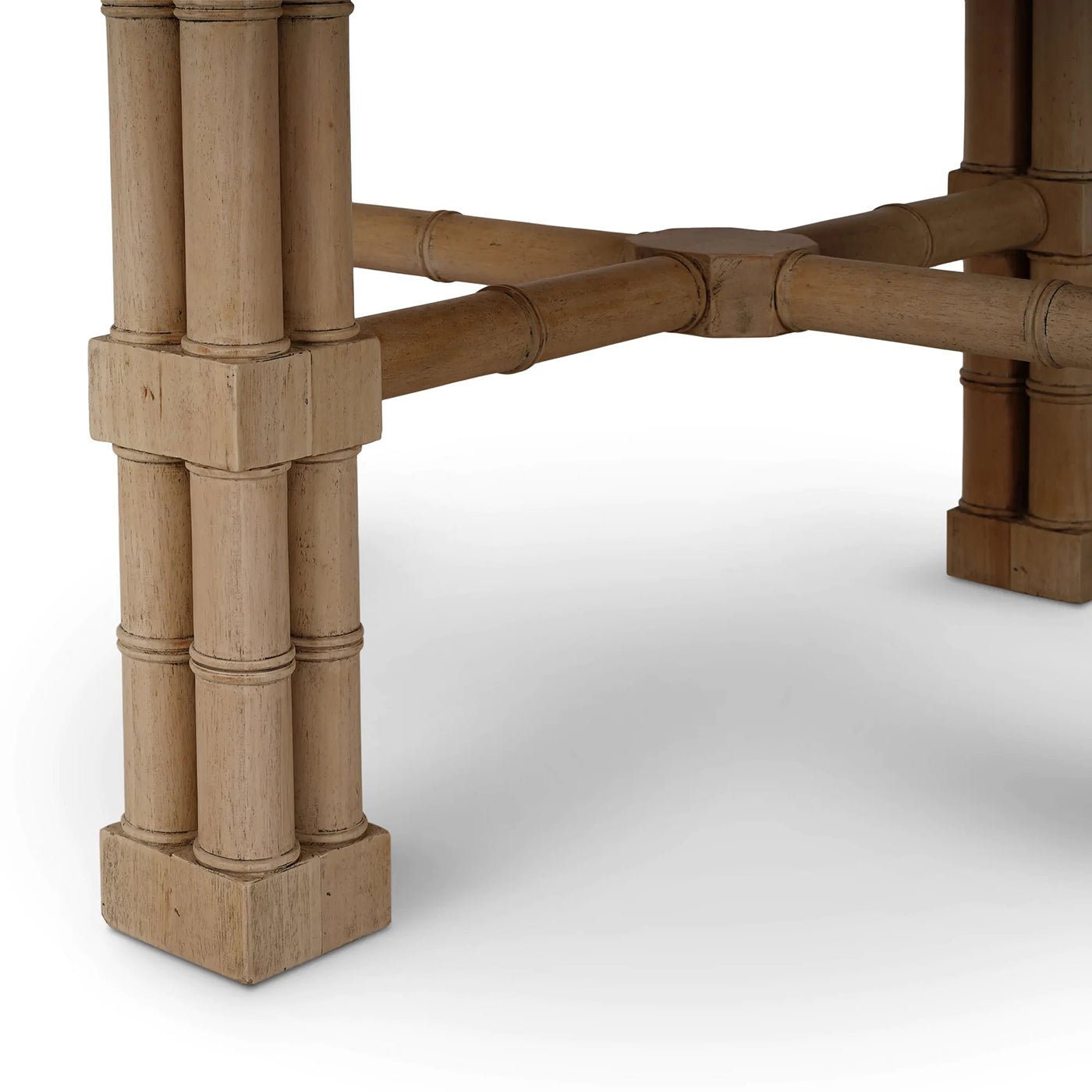 Close-up of bamboo-inspired leg details on dining table.