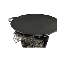 Top angle of round accent table with leaf motif.