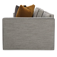 Side view of gray sofa with bold colored pillows.