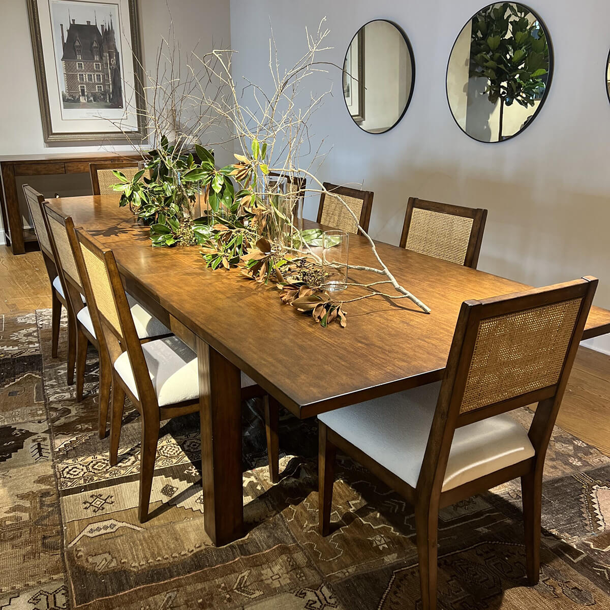Dining room setup, extended Parsons table, chairs arranged.