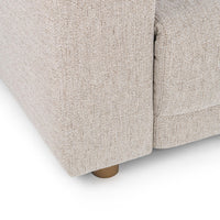 Close-up of gray sectional outer arm and base showing woven upholstery and a short round foot