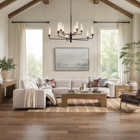 Gray reclining sectional styled in a bright living room with a wood coffee table and ceiling beams