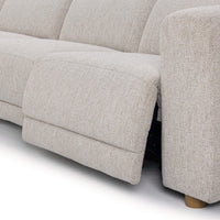 Close-up of gray sectional recliner footrest extended beside the upholstered arm