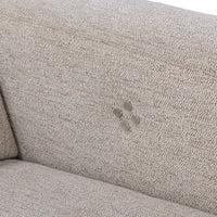 Close-up of four round reclining control buttons on the gray sectional inner arm