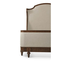 Close-up of the bed's detailed wood and fabric finish.